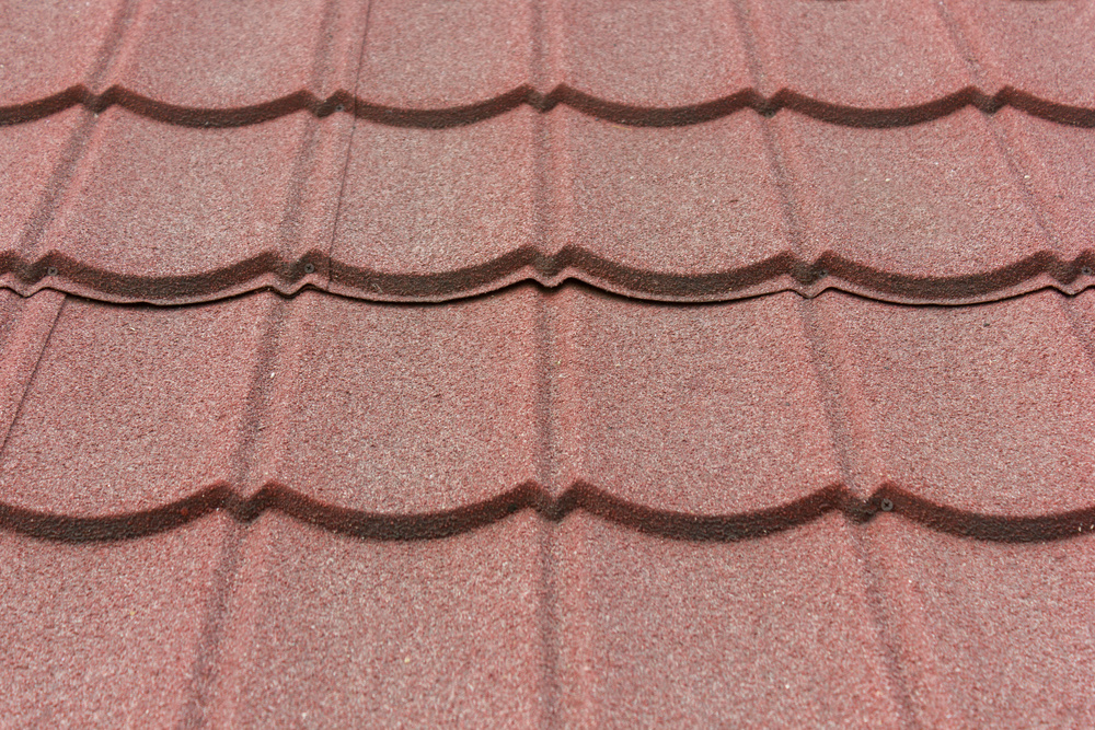 Texture of stone coated steel roof tiles in red color